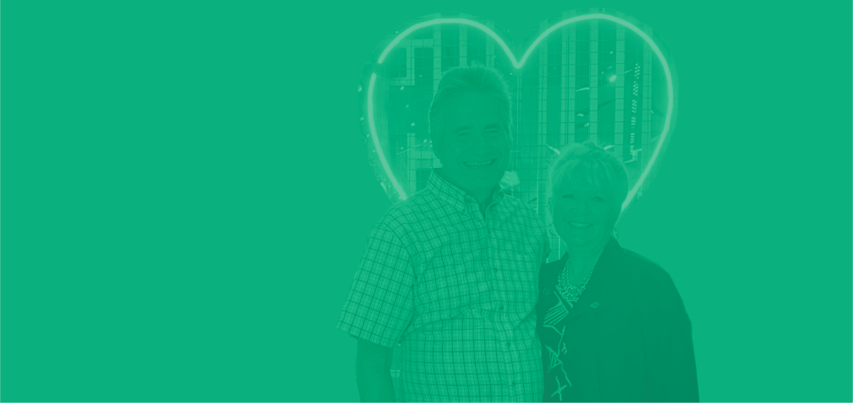 Dale and Linda standing together with a heart-shaped outline on a green background