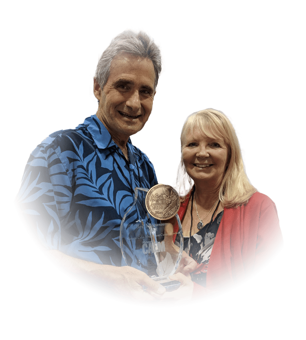 Dale and Linda Bolton holding an award against a transparent background
